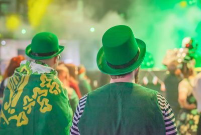 Two,Mans,In,Green,Hats,Enjoy,A,Festive,Atmosphere,During