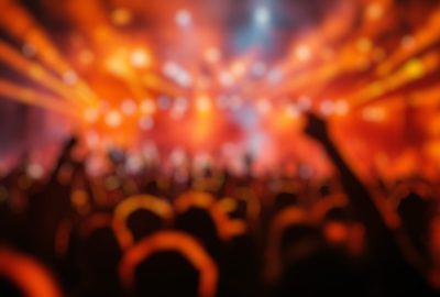 Blur,Background,Of,Energetic,Crowd,Enjoying,Live,Music,Concert,With